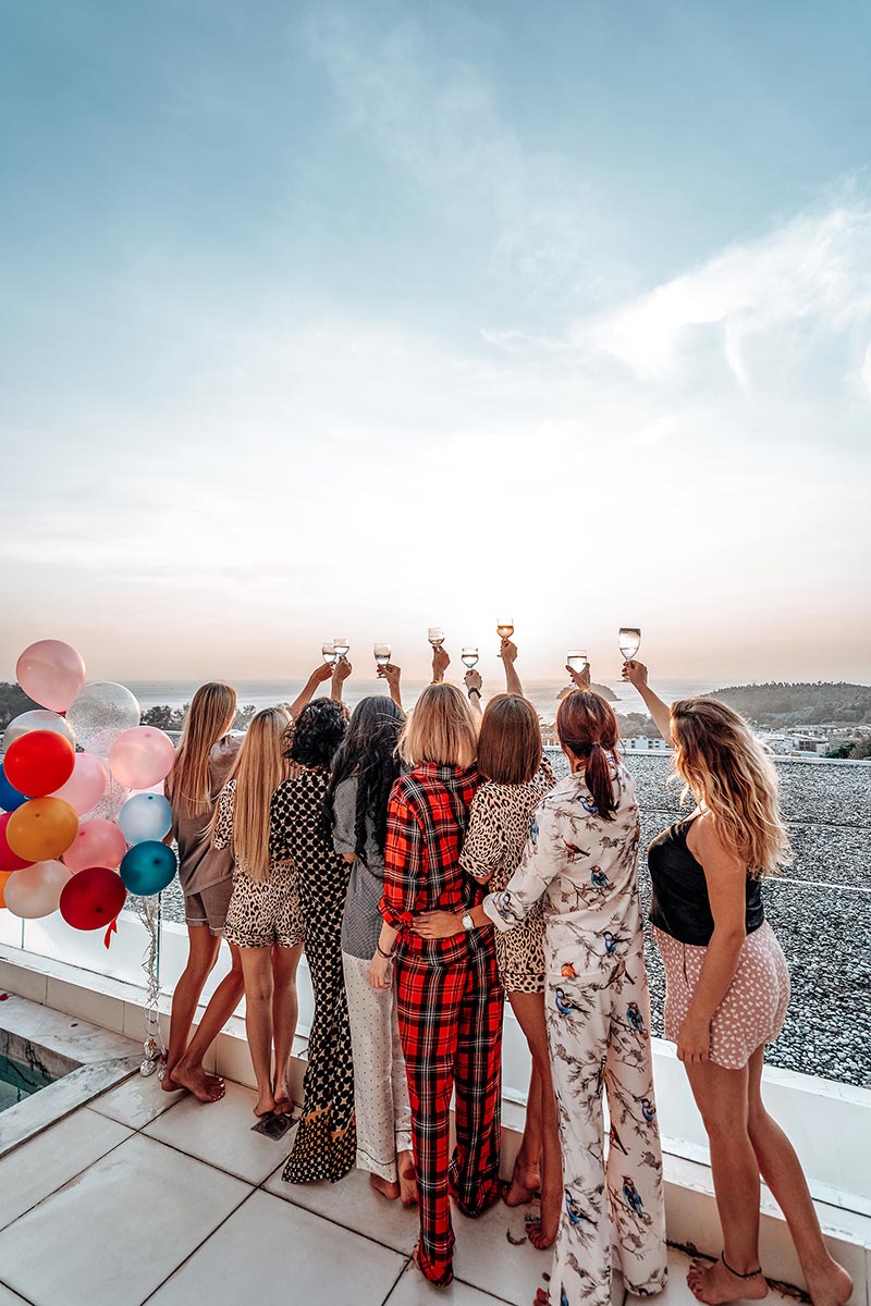 eight-female-friends-rise-their-hands-up-to-sky-ho-2023-11-27-05-35-49-utc