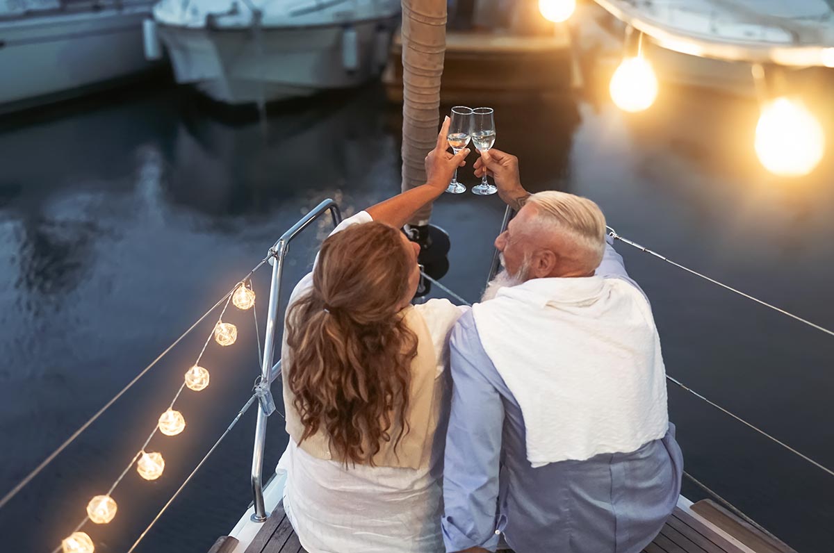 senior-couple-toasting-champagne-on-sailboat-vacat-2024-11-27-11-28-33-utc
