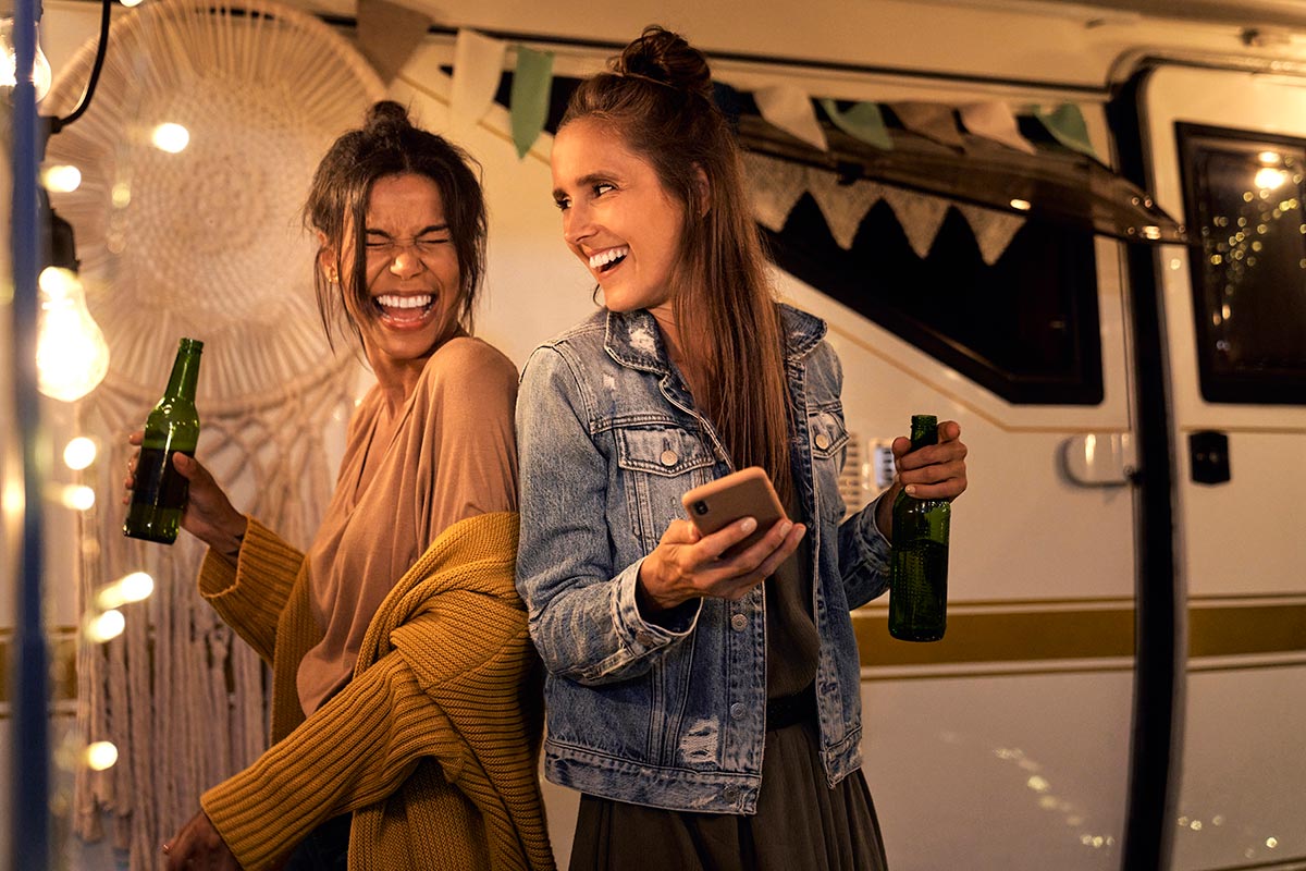 two-girls-having-fun-on-the-camping-side-and-drink-2024-12-02-08-38-18-utc